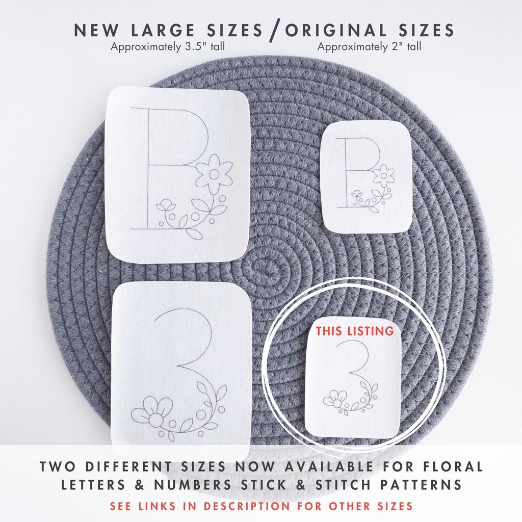 Two white stick and stitch embroidery patterns, a floral letter 'B' and number '3', in original 2" and new 3.5" sizes, on a gray mat.