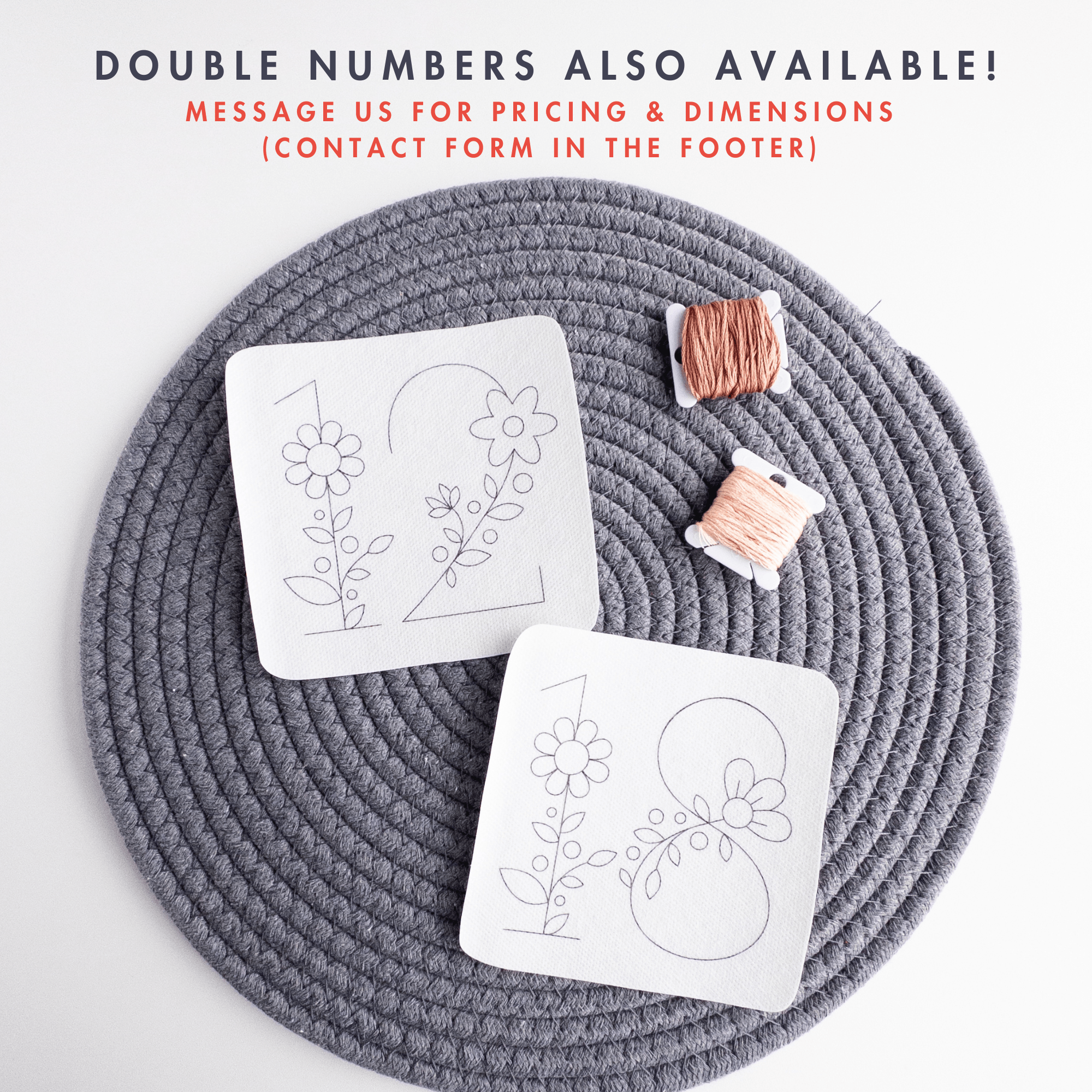 Two white stick and stitch embroidery patterns, "1" and "2" with floral designs, on a gray mat with two spools of peach and copper thread.