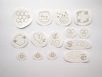 14 white water-soluble stick and stitch patches with black honeybee-themed embroidery designs.