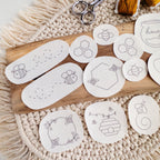 White water-soluble stick and stitch patches with various black honeybee and honeycomb embroidery designs.