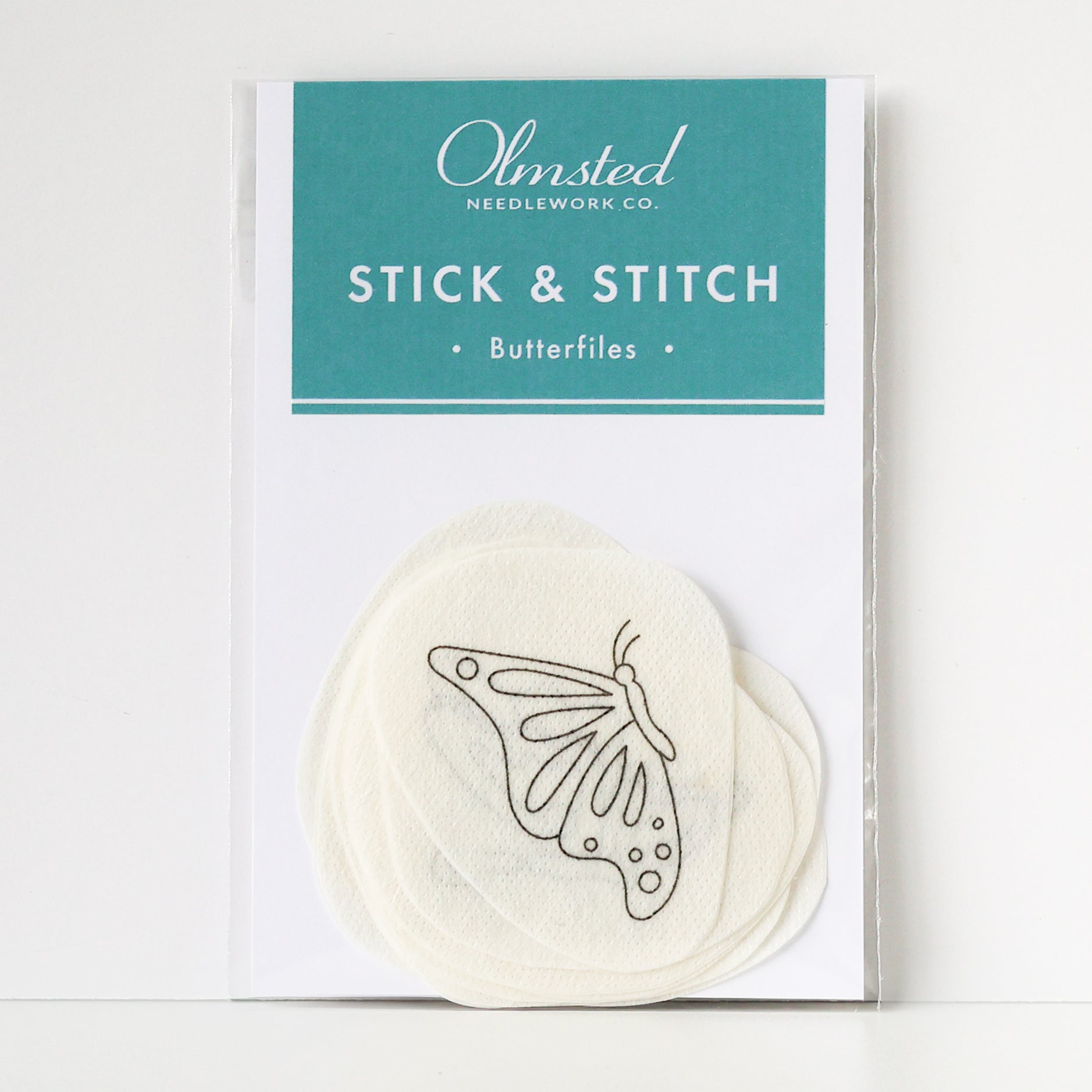 Pack of Olmsted Needlework Co. Stick & Stitch butterfly embroidery patterns on water-soluble paper.