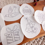 White water-soluble Christmas stick and stitch embroidery patterns: dove, ornament, bells, poinsettia, gift.