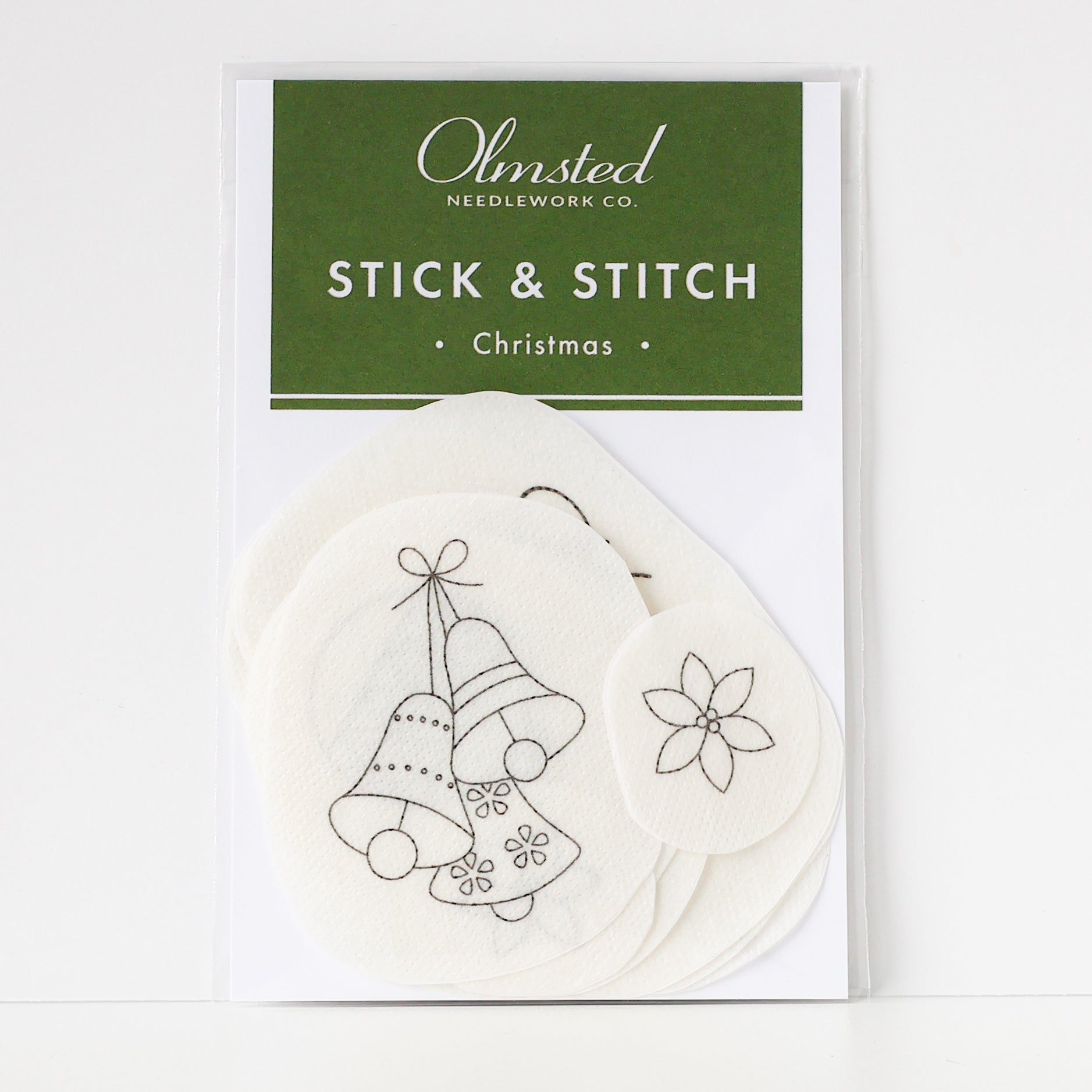 Christmas stick and stitch embroidery patterns on water-soluble stabilizer, featuring bells and a poinsettia.