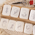 Floral numbers 1-9 stick and stitch embroidery patterns on a wooden board with scissors and thread.