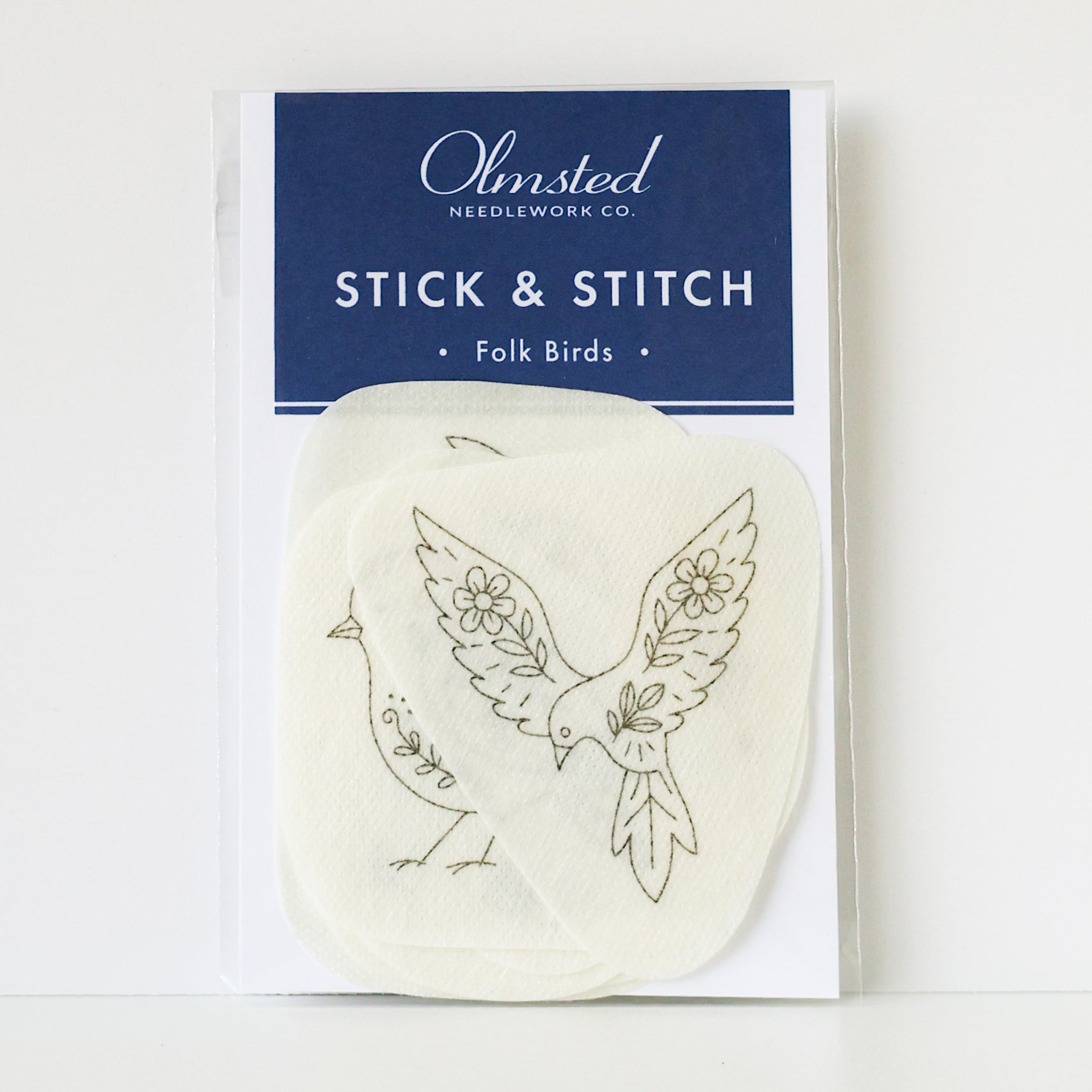 Folk Birds Stick & Stitch embroidery patterns on washaway stabilizer, featuring two cream-colored bird designs.