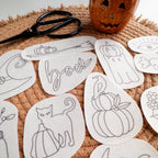Halloween stick and stitch embroidery patterns: ghost, cat, pumpkin, witch hat, and "boo" designs on white stabilizer.