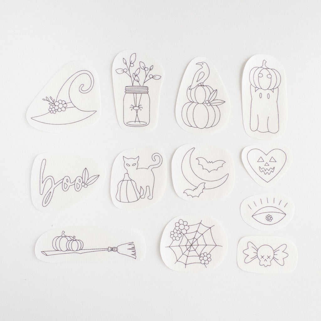 12 Halloween stick and stitch embroidery patterns: witch hat, cat, pumpkins, ghost, spiderweb, broom, and more.