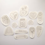 13 beige water-soluble heart embroidery stick and stitch patterns, ranging from 1.1" to 3" in diameter.
