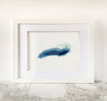 Framed Lake Ontario cross-stitch pattern with blue bathymetric map design on white fabric.