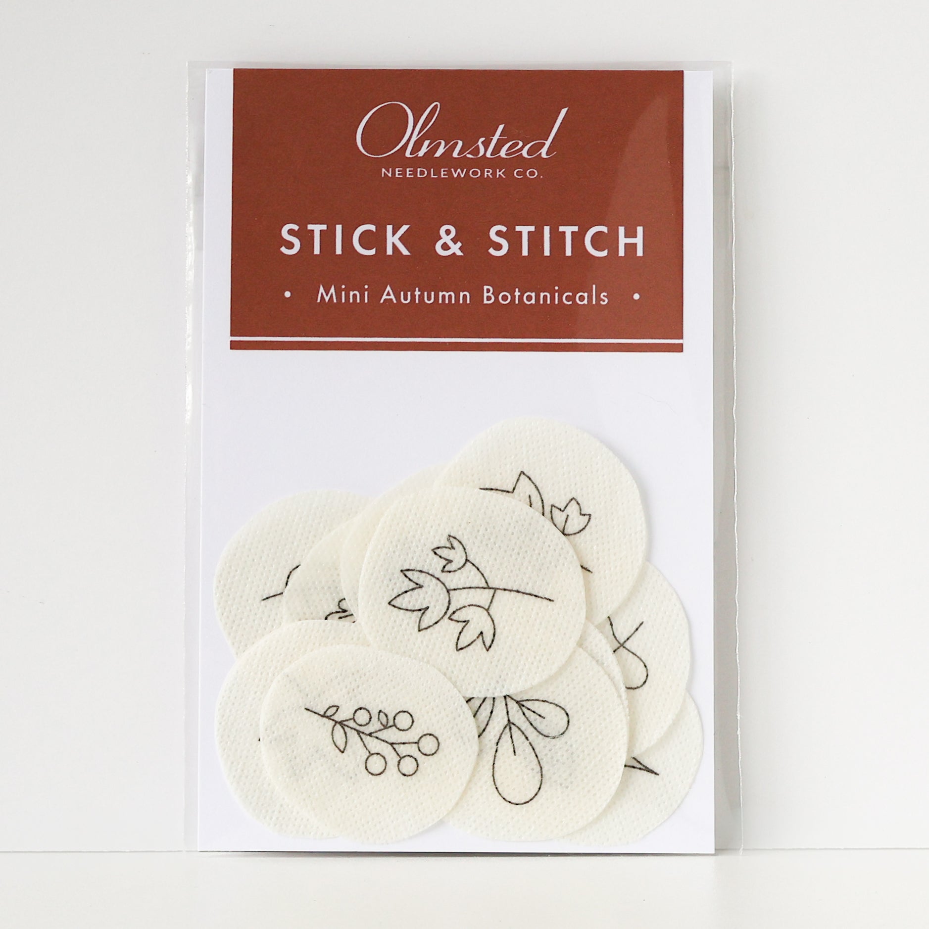 Olmsted Needlework Co. Mini Autumn Botanicals Stick & Stitch embroidery patterns on round, cream water-soluble patches.