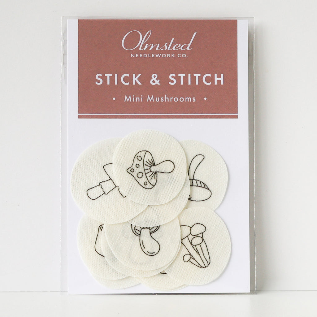 Olmsted Needlework Co. Stick & Stitch mini mushroom embroidery patterns on white water-soluble stabilizer patches.