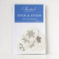 Pack of 12 white, round, water-soluble Stick & Stitch mini snowflake embroidery patterns, 1" diameter.