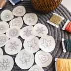 Mini stick and stitch embroidery patterns: hearts, snowflakes, shamrocks, leaves, sunbursts, flowers, orange slices.