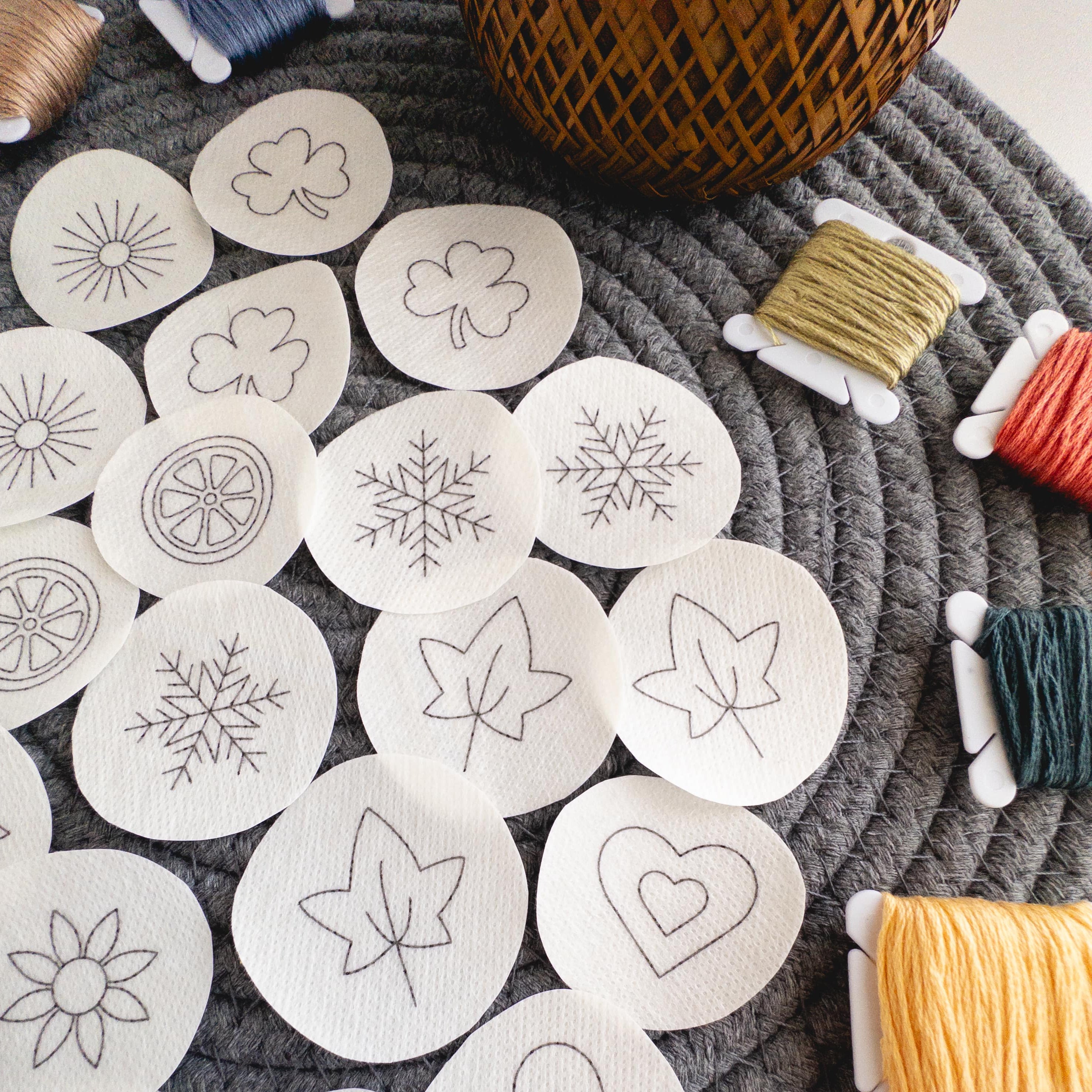 Mini stick and stitch embroidery patterns: hearts, snowflakes, shamrocks, leaves, sunbursts, flowers, orange slices.