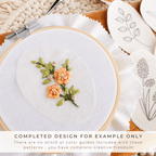 Embroidery hoop with a stitched orange wildflower design and water-soluble stick and stitch patterns.