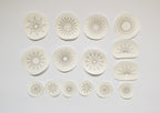 15 sun embroidery patterns on water-soluble stabilizer: large, small, and half-sun designs for fabric upcycling.