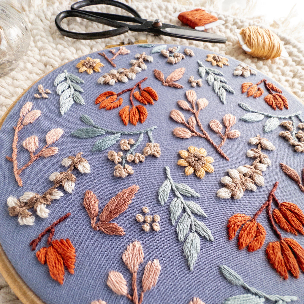 Twilight Meadow embroidery in a 6-inch hoop, featuring fall florals on moody fabric with sunflowers and wild cotton.