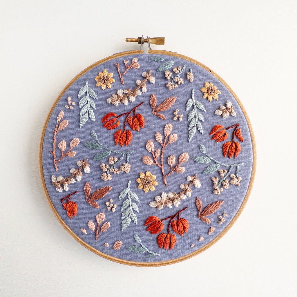 Twilight Meadow embroidery in a 6-inch hoop, featuring fall florals on moody fabric with sunflowers and wild cotton.