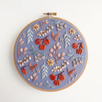 Twilight Meadow embroidery in a 6-inch hoop, featuring fall florals on moody fabric with sunflowers and wild cotton.