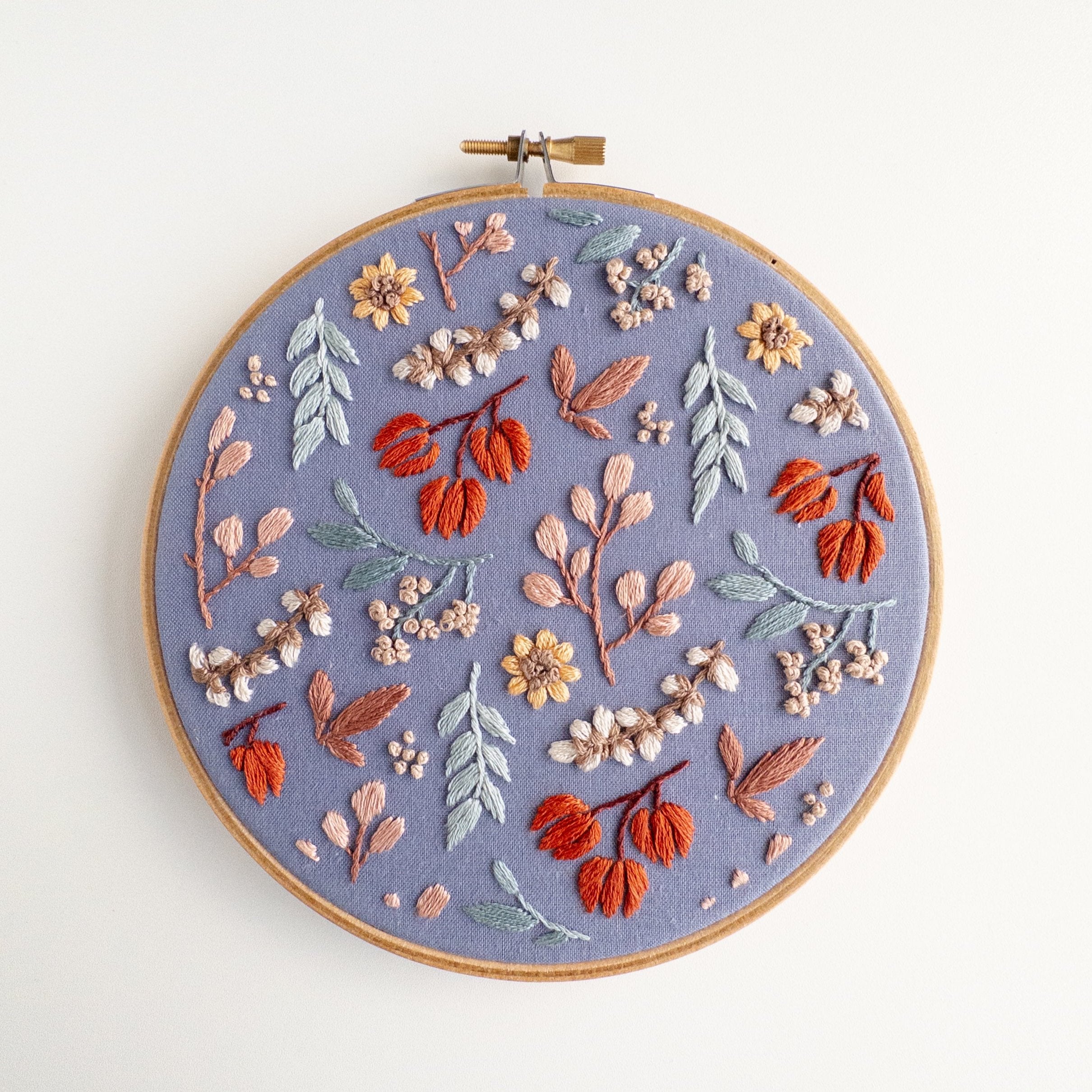 Twilight Meadow embroidery in a 6-inch hoop, featuring fall florals on moody fabric with sunflowers and wild cotton.
