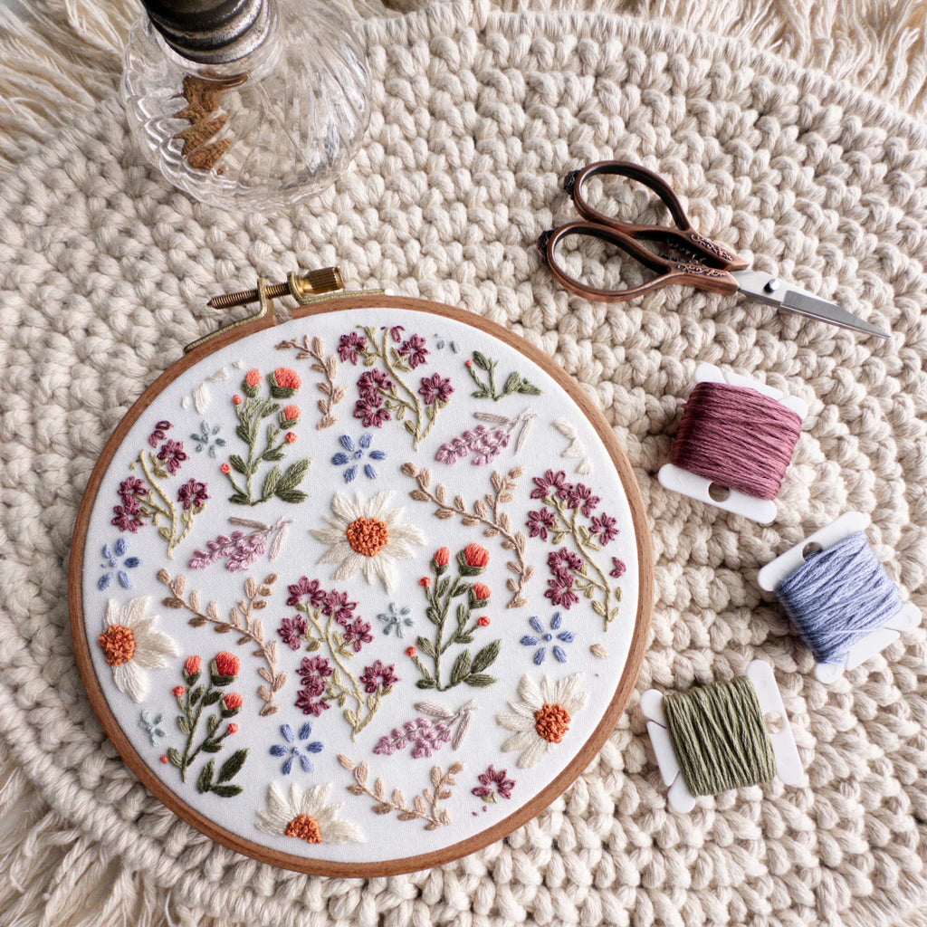 Embroidered wildflower field pattern in a 6-inch hoop with daisies, lavender, and colorful threads.