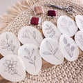 Wildflower stick and stitch embroidery patterns on water-soluble stabilizer, with floss and scissors.